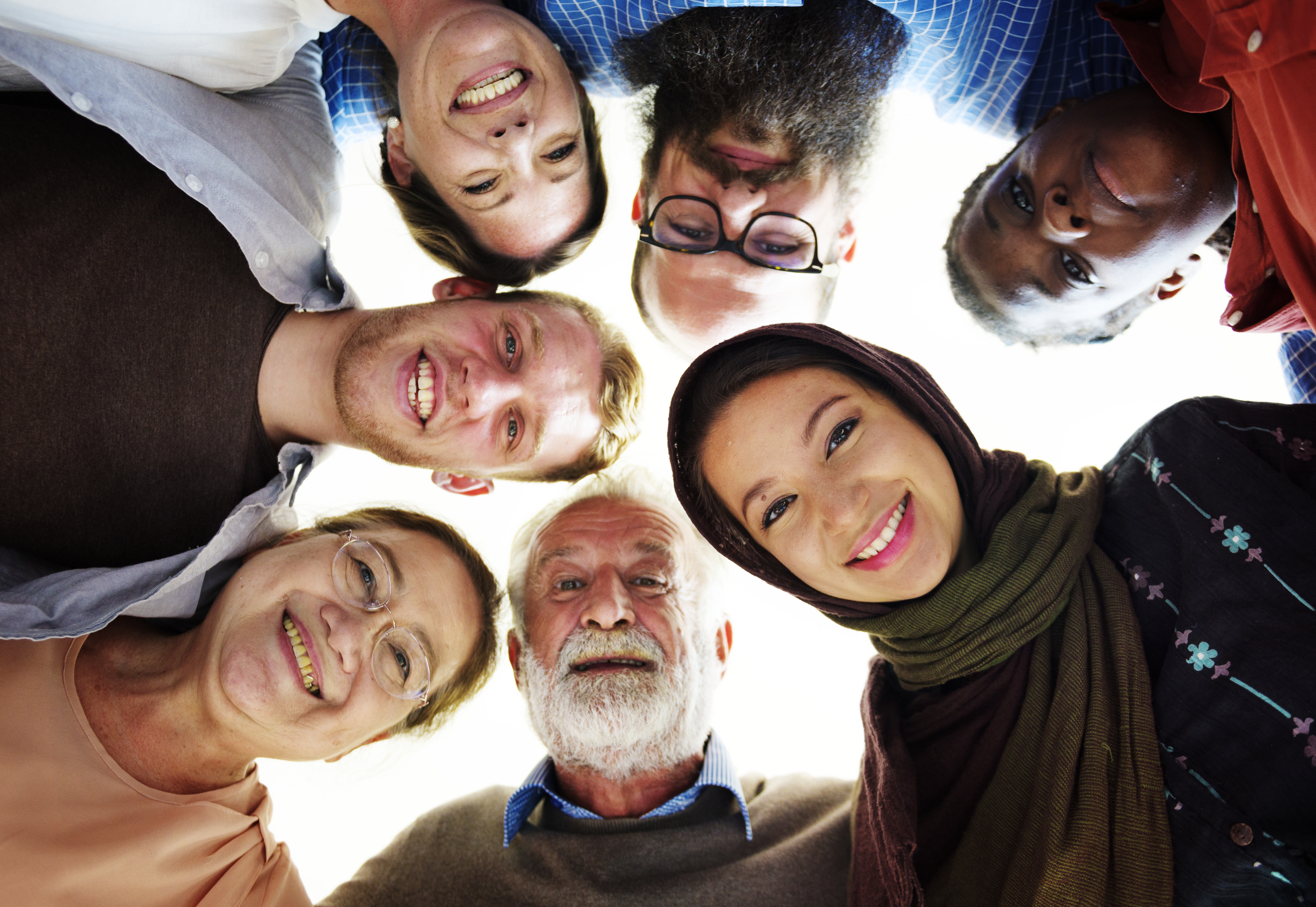 7 new Canadians from all different countries in a circle smiling