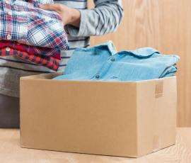 Man Sorting Box of Clothing 