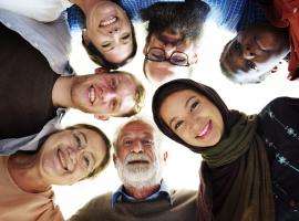 7 new Canadians from all different countries in a circle smiling